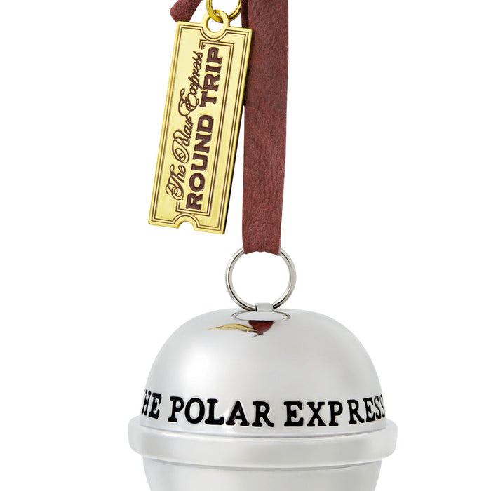 Decorative bell with 'The Polar Express' text and a gold ticket tag on a white background