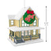 Christmas ornament of a house with a wreath displaying 'A Christmas Story' on a white background.