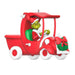 Decorative ornament of the Grinch in a red truck sleigh with a wreath on a white background