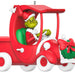 Decorative ornament of the Grinch driving a red car with a wreath on a white background