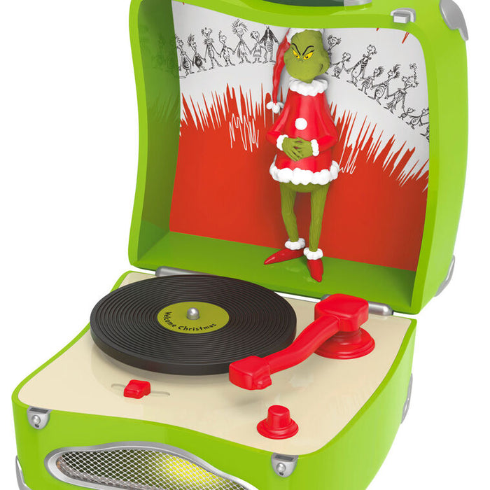 Toy record player with a Grinch figure on the cover