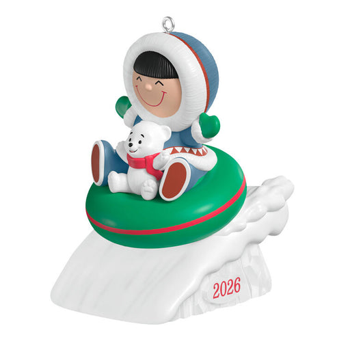 Christmas ornament featuring a child in a snowy scene with a polar bear, on a white background.