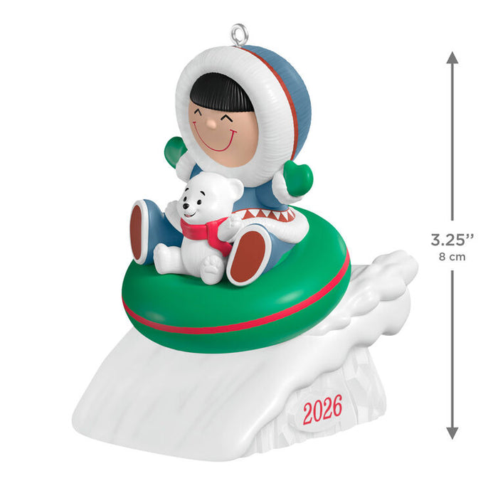 Christmas ornament with a child and polar bear on an inner tube, featuring the year 2026.