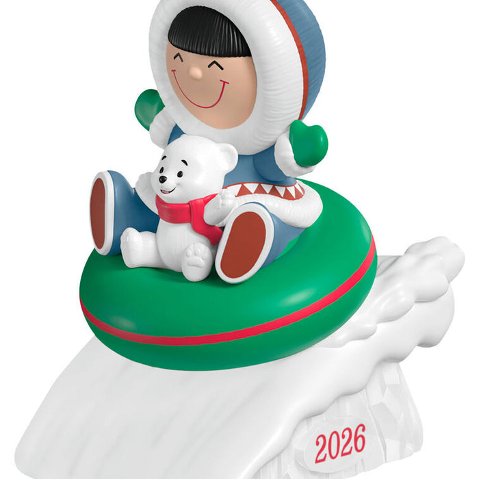 Decorative figurine with a child in winter clothing and a polar bear on a green ring, with '2026' printed below.