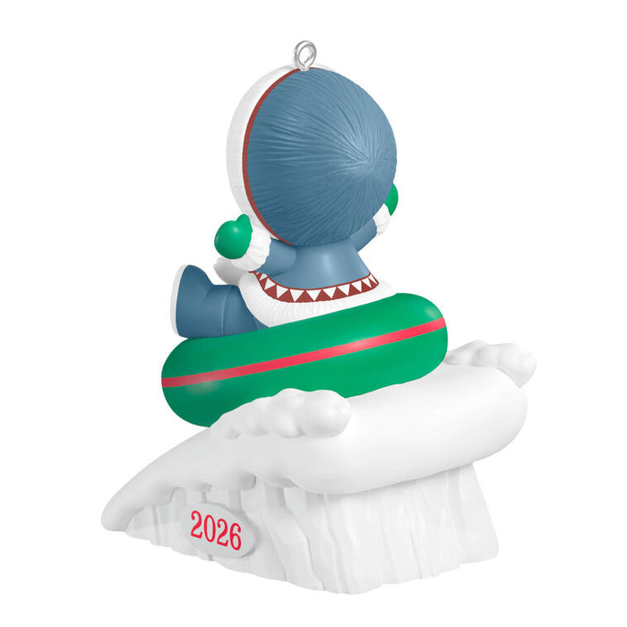 Decorative ornament with a character on a sledding tube, featuring the year 2026.