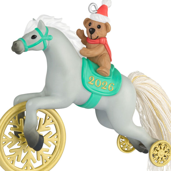 Christmas ornament with a teddy bear riding a toy pony, featuring the year 2026.