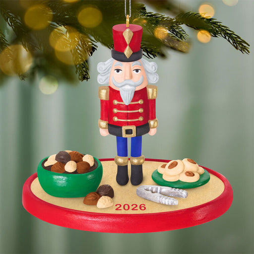 Christmas ornament of a nutcracker with cookies and nuts on a green background