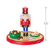 Christmas nutcracker figurine with a bowl of nuts and a measurement label on a white background