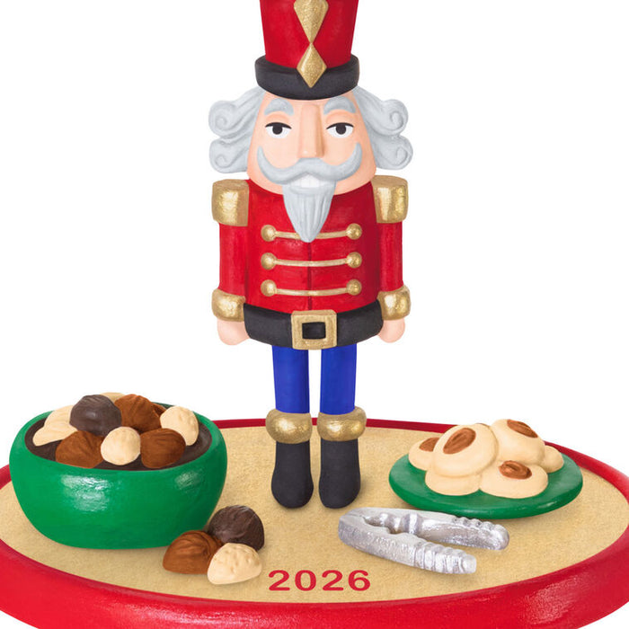 Christmas nutcracker figurine with cookies and nuts on a white background