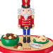 Christmas nutcracker figurine with cookies and nuts on a white background