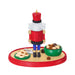 Nutcracker figurine with a red uniform, white hair, and blue pants on a white background