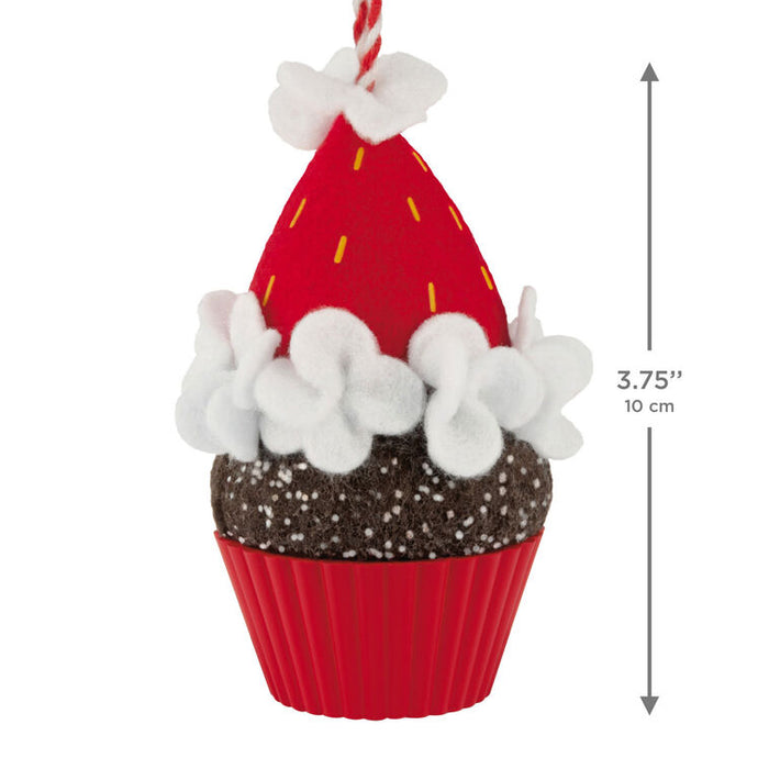 Decorative cupcake ornament with red icing, white frosting, and chocolate base, featuring a measurement label.