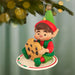 Elf ornament holding a cookie, hanging on a Christmas tree.