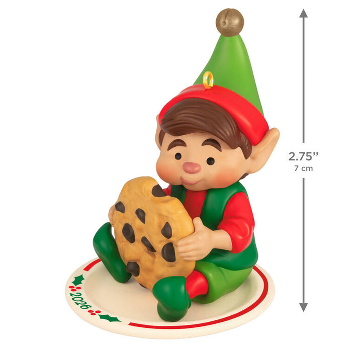 Elf figurine holding a cookie with dimensions indicated on a white background