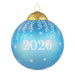 Blue Christmas ornament with '2026' and snowflake patterns on a white background