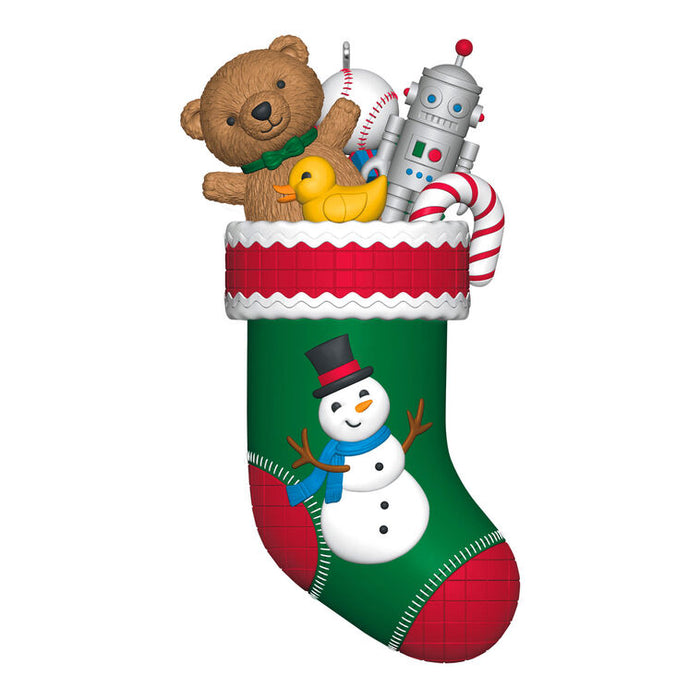 Christmas stocking with toys including a teddy bear, robot, and duck on a white background