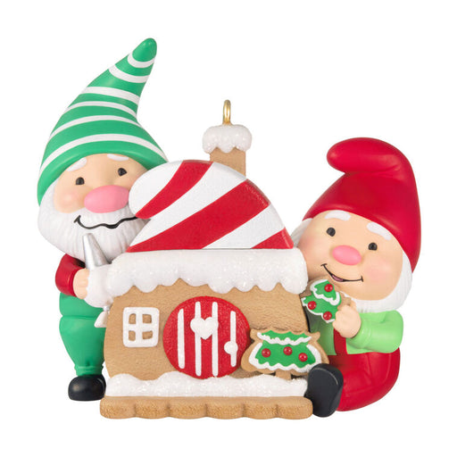 Decorative Christmas ornament with two gnomes and a gingerbread house on a white background