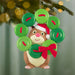 Christmas ornament of a hamster with a wreath made of buttons and red bow, hanging on a tree.
