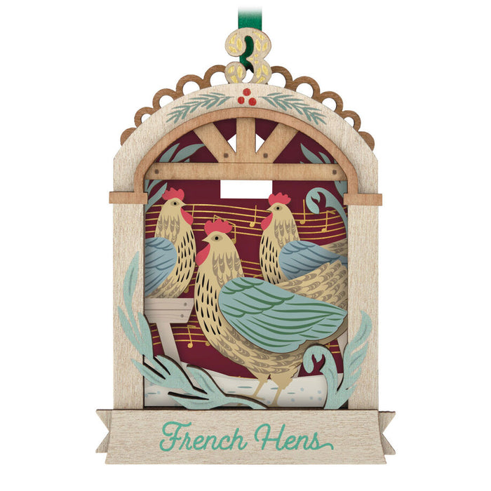 Decorative ornament with chickens and the text 'French Hens' on a white background
