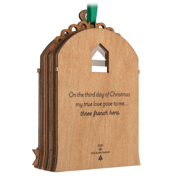 Wooden ornament with engraved text on a white background