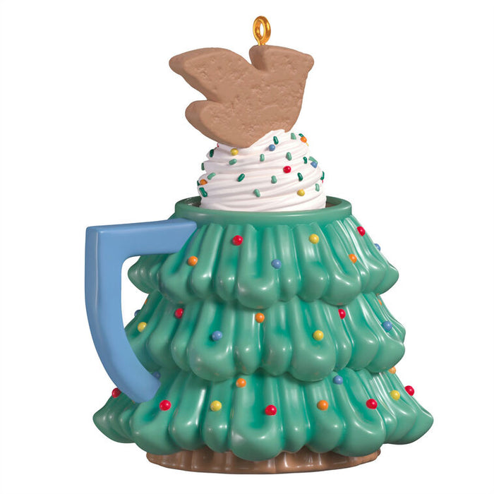 Christmas ornament shaped like a mug with a tree design with a swirl of whipped cream and sparkles and topped with a cardinal cookie on top