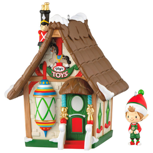 Decorative toy house with a small elf figure on a white background