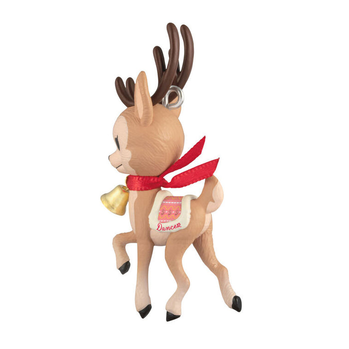 Reindeer ornament with a red scarf and bell on a white background
