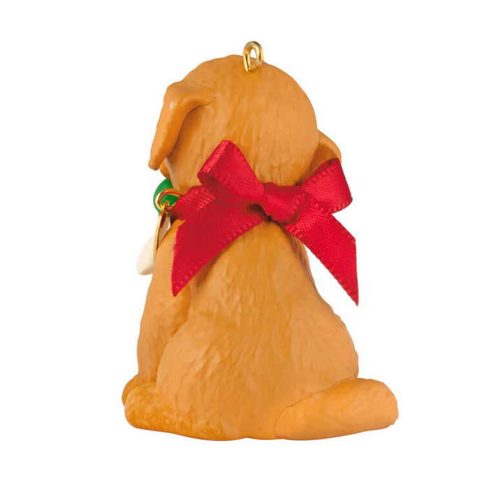 Dog ornament with a red bow on a white background