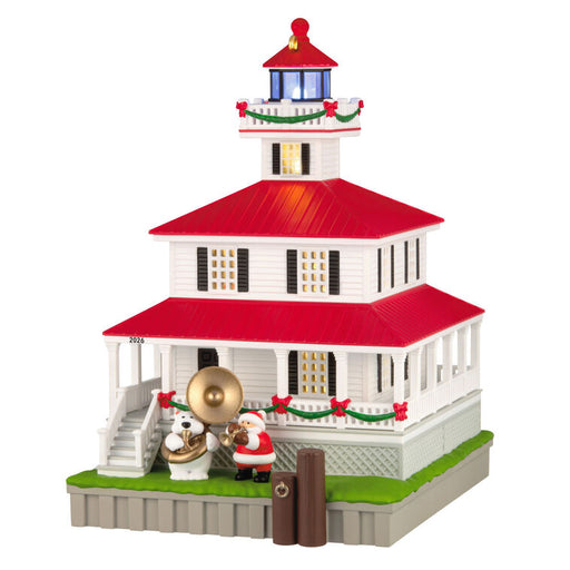 Decorative lighthouse model with Santa Claus and polar bear on a white background