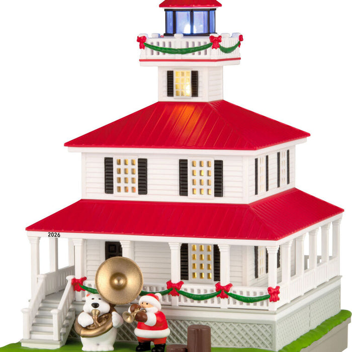 Decorative lighthouse model with Santa Claus and polar bear on a white background