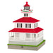 Model of a lighthouse with a red roof and white base on a white background