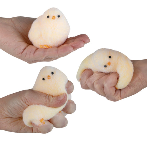 Three small plush chickens held in different hands against a white background