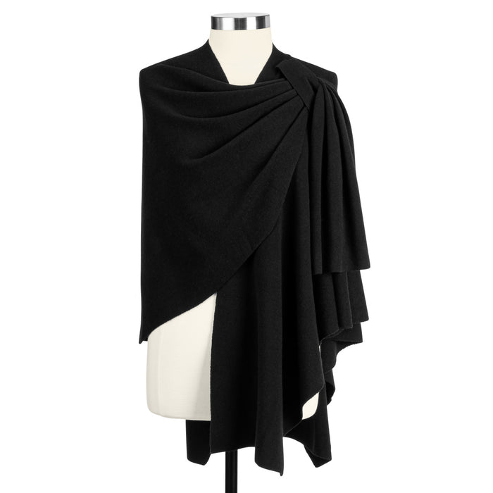 Black draped garment on a mannequin against a white background