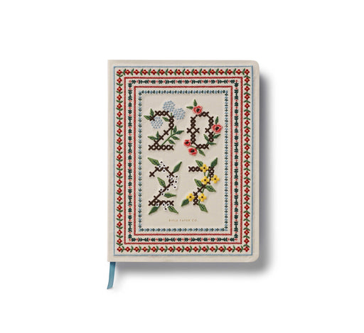 Decorative notebook with floral and geometric design on a white background