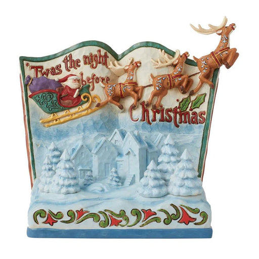 Decorative figurine with Santa Claus and reindeer, featuring 'Twas the night before Christmas text.