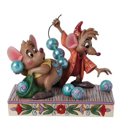 Two animated mouse figurines with colorful balls on a decorative base