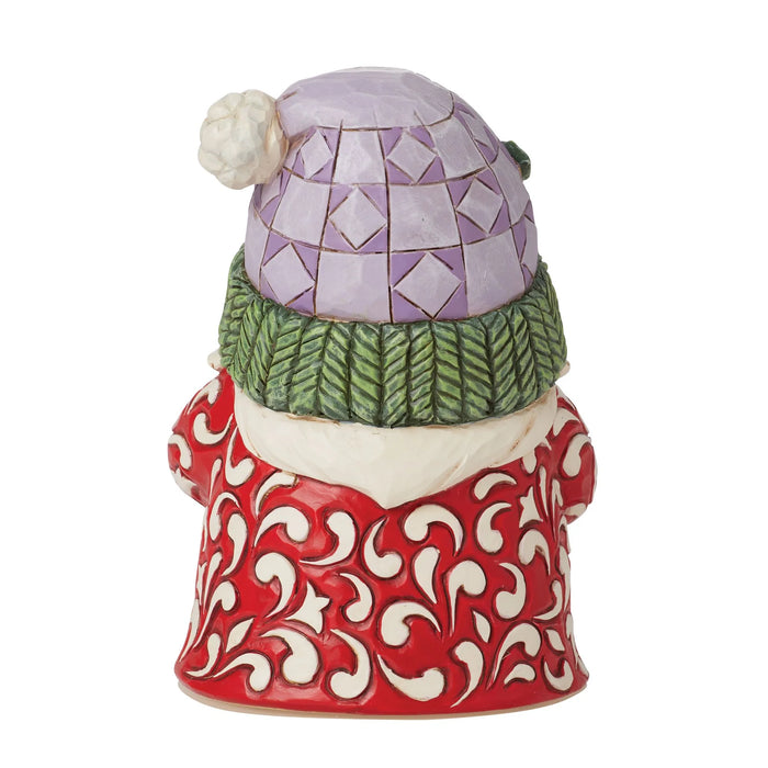 Decorative gnome figurine with a patterned hat and red outfit on a white background