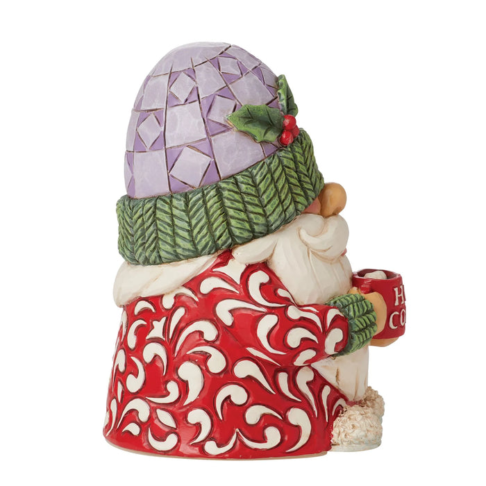 Decorative gnome figurine with a colorful hat and red patterned outfit on a white background