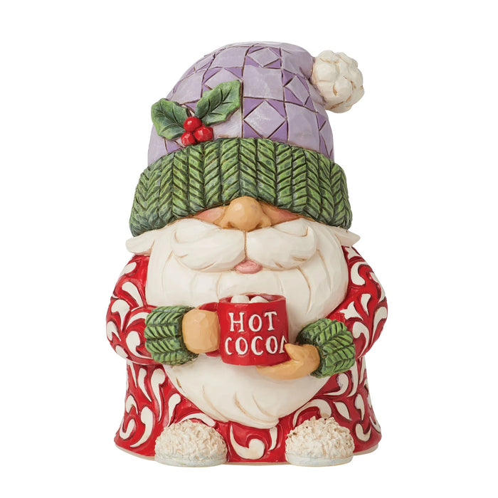 Decorative gnome figurine holding a mug of hot cocoa with a white background