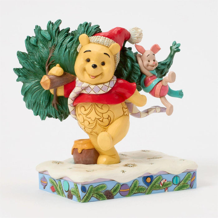 Christmas-themed figurine of a bear and piglet with a tree on a white background