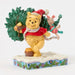 Christmas-themed figurine of a bear and piglet with a tree on a white background