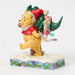 Figurine of Winnie the Pooh and Piglet with Christmas tree on a white background