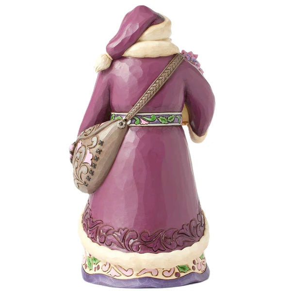 Figurine of a person in a purple outfit with a beige bag on a white background