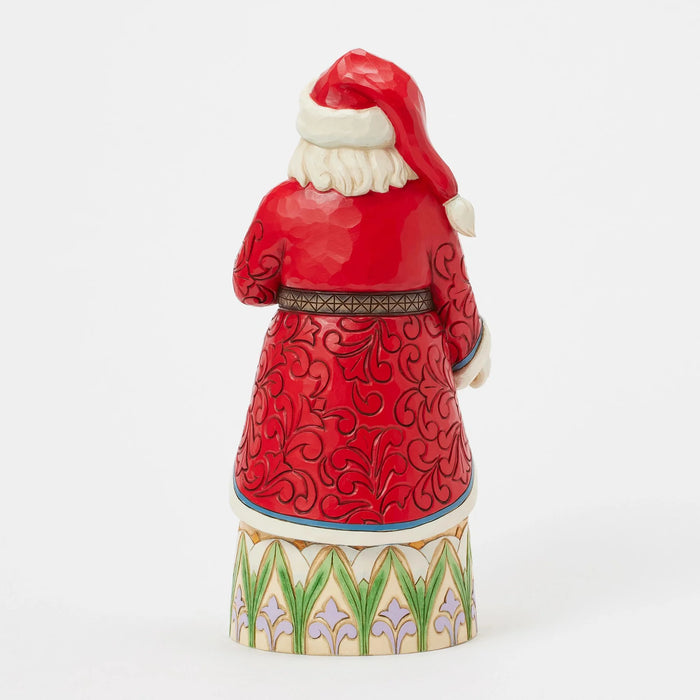 Decorative figurine of a Santa Claus in red suit with white beard on a white background