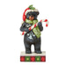 Christmas bear figurine holding a candy cane on a white background