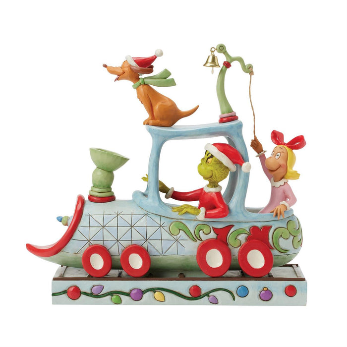 Colorful Christmas-themed figurine with characters on a train-like structure.