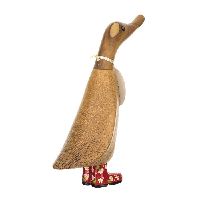 Wooden duck figure with red floral boots on a white background