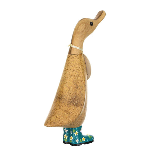 Wooden duck figure with floral-patterned boots on a white background