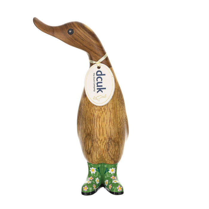 Wooden duck figurine with green boots on a white background
