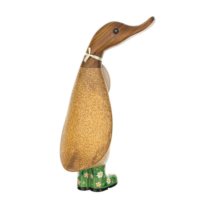 Wooden duck figurine with green boots on a white background